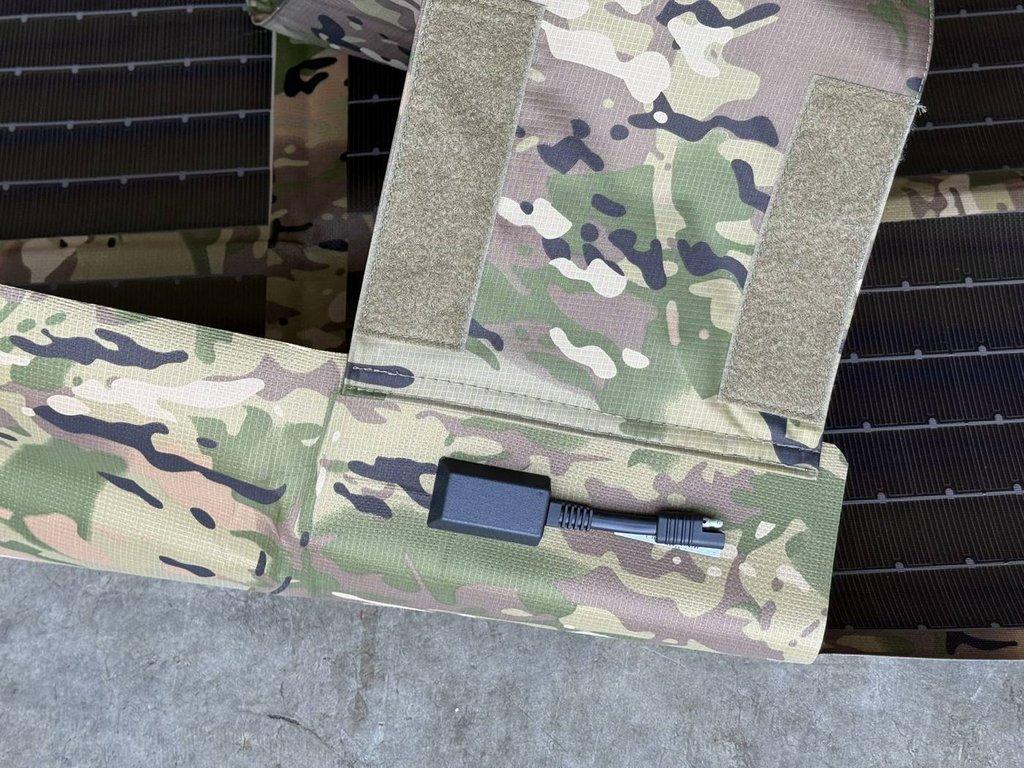 Output lead stowed in the sealed pocket with hook-and-loop closure